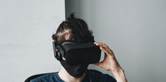 man in blue crew neck shirt wearing black vr goggles