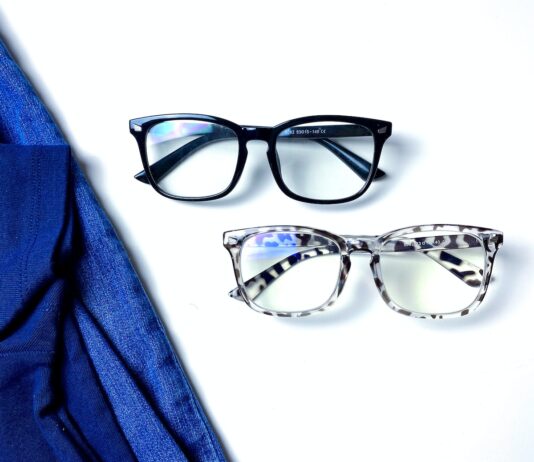 a pair of glasses sitting on top of a white surface