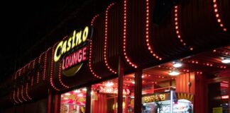 a lit up store front at night with a lot of lights