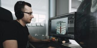 man in black tank top wearing black sunglasses using computer