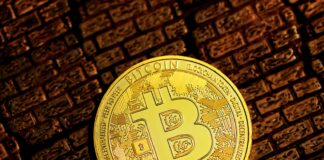 gold round coin on brown textile