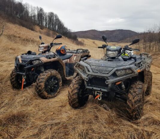 black and gray atv on brown field during daytime