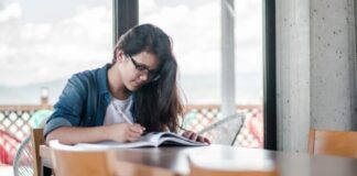 woman writing on book
