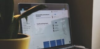 black and silver laptop computer beside yellow ceramic mug