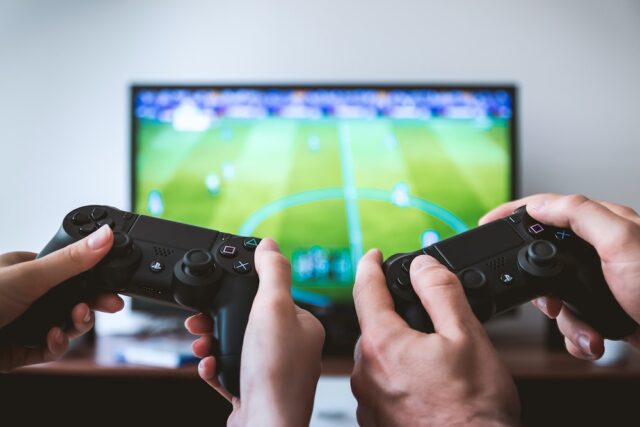 two-people-playing-sony-ps4-game-console two people playing Sony PS4 game console