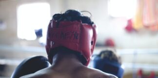 man wearing red head protector and gloves