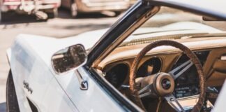 white vehicle parks on road during daytime