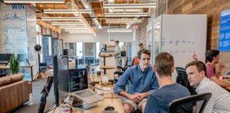 three men sitting on chair beside tables