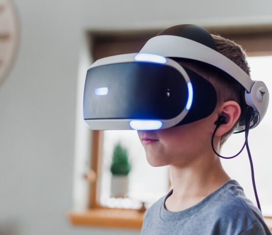 boy wearing black and white VR headset