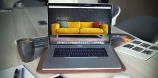 turned on MacBook Pro beside gray mug