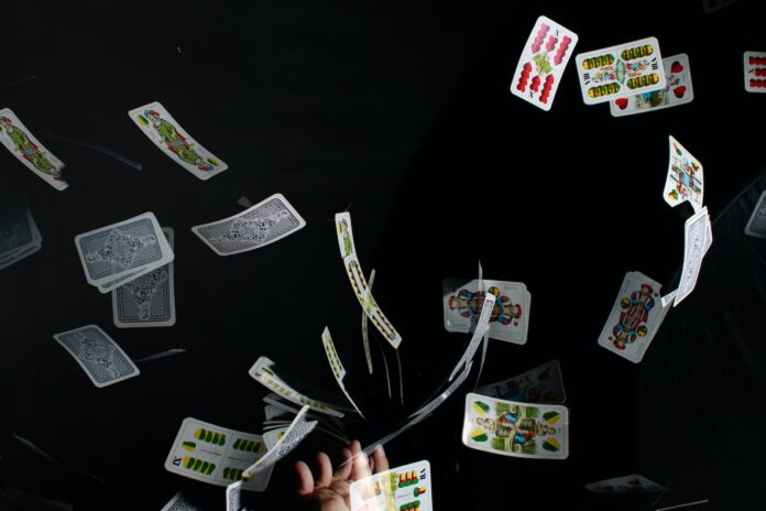 Photo by Roth Melinda playing cards on black textile