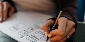 person writing on white paper