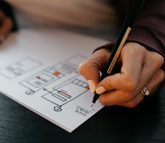 person writing on white paper