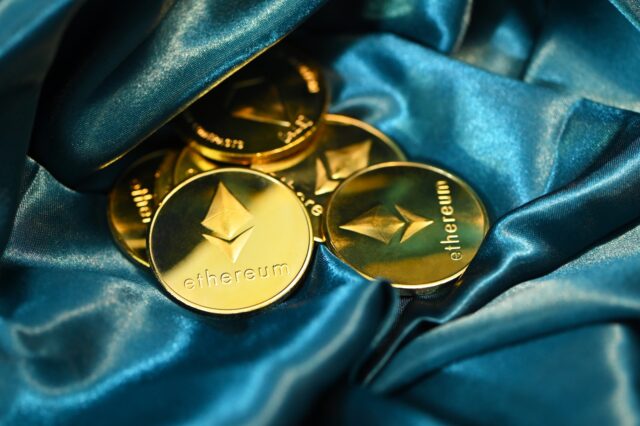 Photo by Traxer a close up of some gold buttons on a blue cloth