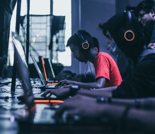 man playing on laptop