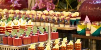 assorted color of cupcakes on gray metal rack