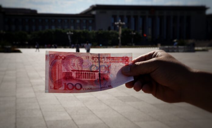 Photo by Bernd 📷 Dittrich a person holding a piece of paper with a picture of a building in the background