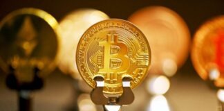 a bitcoin on a stand in front of other bitcoins