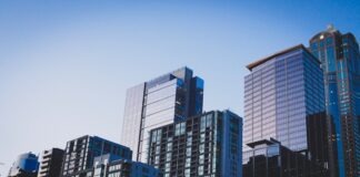 white and blue glass walled high rise building