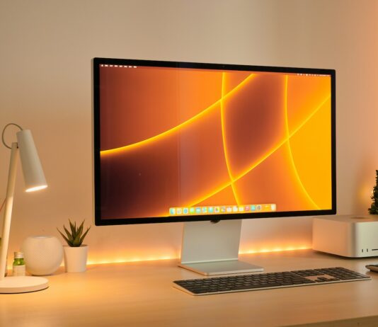a computer monitor sitting on top of a desk