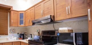 white microwave oven on brown wooden kitchen cabinet