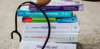 a woman's feet on a stack of books with a stethoscope