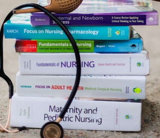 a woman's feet on a stack of books with a stethoscope