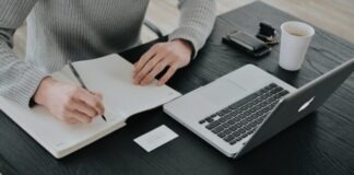 person in white dress shirt holding white paper
