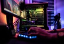 PvP Tips for Each Class in Diablo 4 a person working on a computer in a dark room