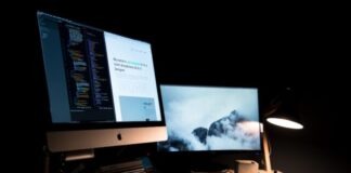 silver iMac turned on inside room