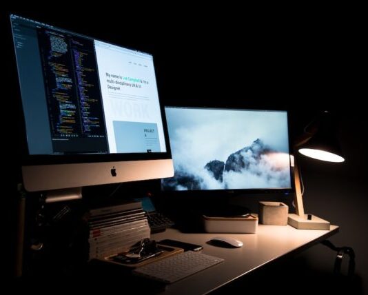 silver iMac turned on inside room