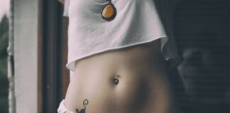 woman in white crop shirt with tattoo on her belly
