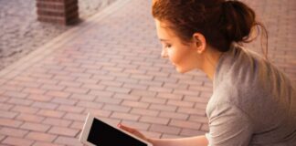woman holding white iPad