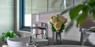 white roses on white ceramic sink