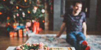 man sitting on the area rug
