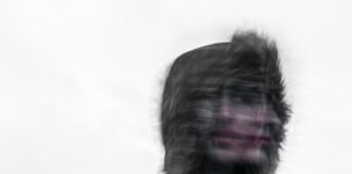 Creepy blurred photo of a person's face and a furry hood