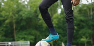 person in blue nike soccer shoes and black pants