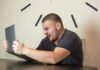 a man sitting in front of a laptop computer