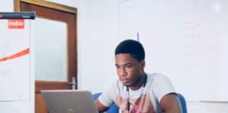 man in grey shirt using grey laptop computer