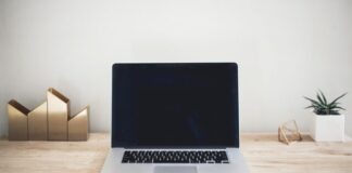 MacBook Pro on top of brown table