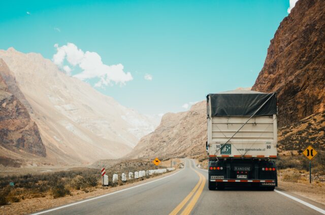 Photo by Rodrigo Abreu white and black truck near mountain at daytime