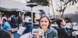 person taking photo of woman