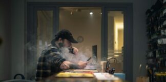 man in black and white plaid dress shirt sitting at the table