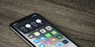 black iphone 5 on brown wooden table