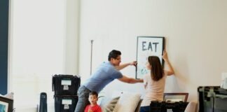 woman in blue denim jacket standing beside woman in black shirt