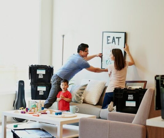 woman in blue denim jacket standing beside woman in black shirt