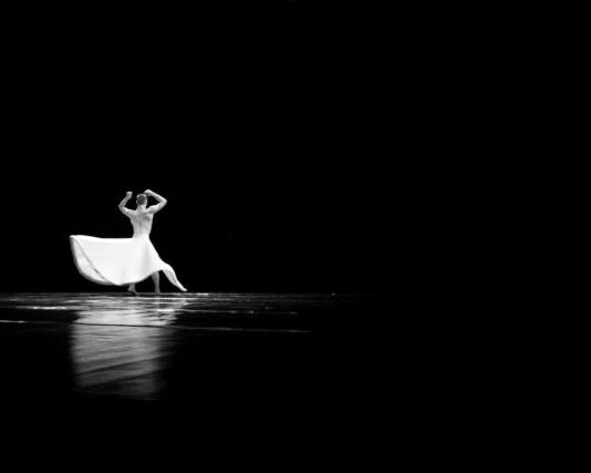 woman in white dress walking on water