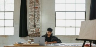 a man sitting at a table working on a laptop