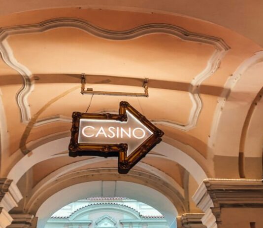 a casino sign hanging from the ceiling of a building
