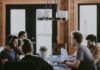 sittin people beside table inside room
